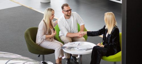 Happy customers in car dealership